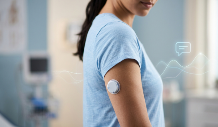 Wearable glucose biosensor on a person's arm with a subtle data-graph overlay representing AI-powered glucose insights